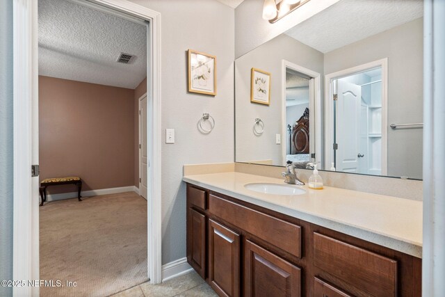 11725 Paddock Gates Dr, Jacksonville, FL 32223 - bathroom with vanity, a textured ceiling, and baseboards