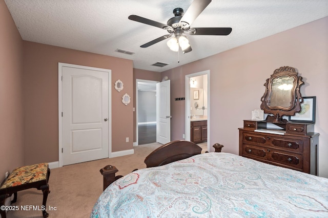 11725 Paddock Gates Dr, Jacksonville, FL 32223 - bedroom featuring light carpet, baseboards, ensuite bath, a ceiling fan, and a textured ceiling