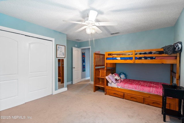 11725 Paddock Gates Dr, Jacksonville, FL 32223 - carpeted bedroom featuring a closet, a textured ceiling, and a ceiling fan