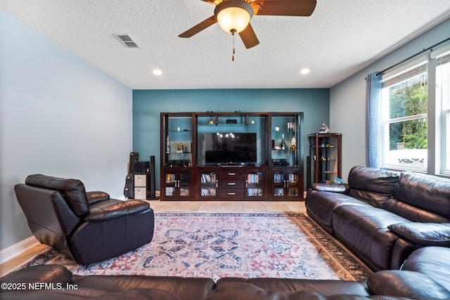 11725 Paddock Gates Dr, Jacksonville, FL 32223 - tiled living area with ceiling fan, a textured ceiling, and recessed lighting