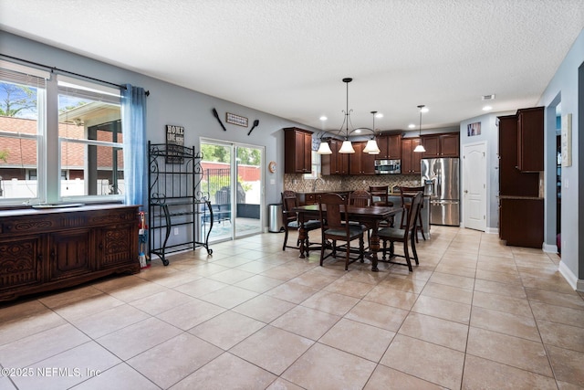 11725 Paddock Gates Dr, Jacksonville, FL 32223 - dining area with light tile patterned flooring, a textured ceiling, and recessed lighting