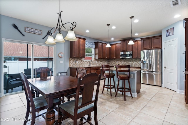 11725 Paddock Gates Dr, Jacksonville, FL 32223 - dining room with light tile patterned floors and recessed lighting
