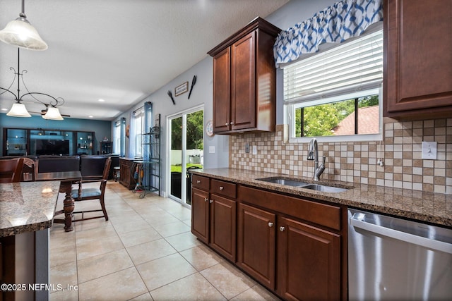 11725 Paddock Gates Dr, Jacksonville, FL 32223 - kitchen with dishwasher, a sink, decorative backsplash, light tile patterned floors, and pendant lighting
