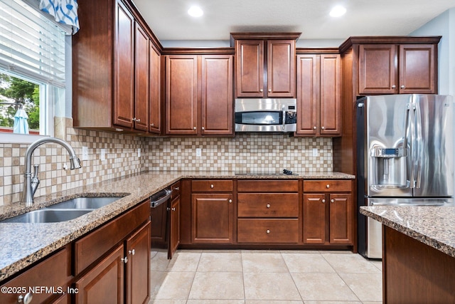 11725 Paddock Gates Dr, Jacksonville, FL 32223 - kitchen featuring appliances with stainless steel finishes, a sink, light tile patterned flooring, light stone countertops, and tasteful backsplash