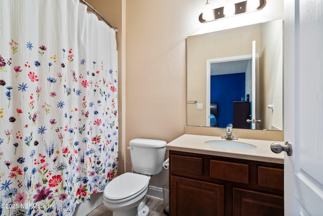 11725 Paddock Gates Dr, Jacksonville, FL 32223 - full bath with vanity, toilet, a shower with shower curtain, and a textured wall