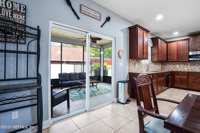 11725 Paddock Gates Dr, Jacksonville, FL 32223 - kitchen featuring stainless steel microwave, decorative backsplash, ceiling fan, a sink, and stone counters