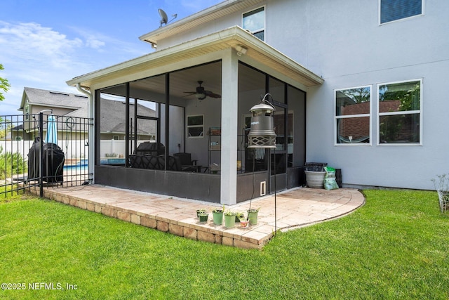 11725 Paddock Gates Dr, Jacksonville, FL 32223 - rear view of house featuring a sunroom, a ceiling fan, stucco siding, and a patio