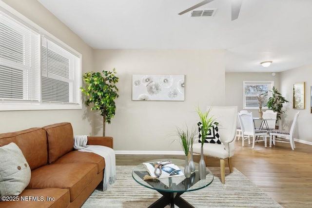 10625 Dodd Rd, Jacksonville, FL 32218 - living room featuring visible vents, ceiling fan, baseboards, and wood finished floors