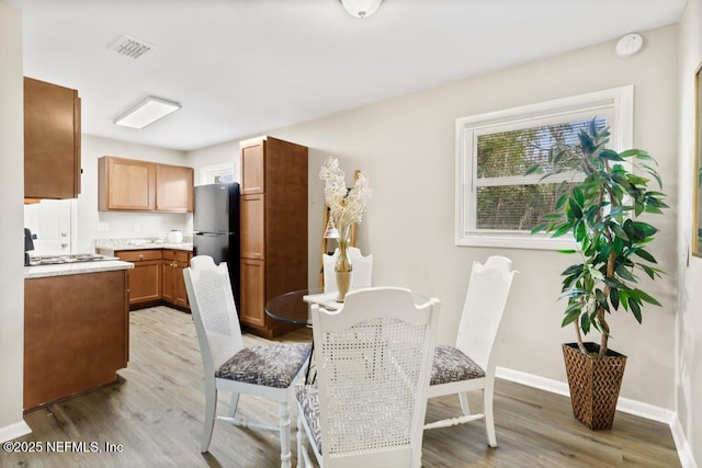 10625 Dodd Rd, Jacksonville, FL 32218 - dining space featuring visible vents, light wood-style flooring, and baseboards