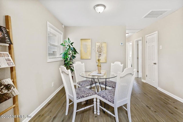 10625 Dodd Rd, Jacksonville, FL 32218 - dining area with visible vents, baseboards, and wood finished floors