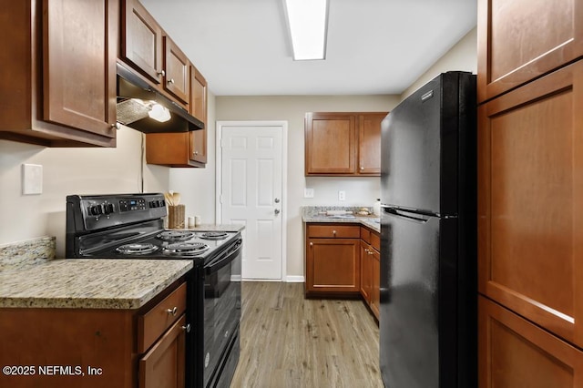 10625 Dodd Rd, Jacksonville, FL 32218 - kitchen featuring brown cabinets, black appliances, light wood-style floors, and under cabinet range hood