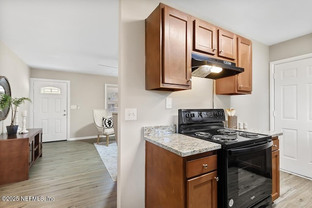 10625 Dodd Rd, Jacksonville, FL 32218 - kitchen featuring baseboards, light stone counters, light wood-style flooring, electric range, and under cabinet range hood