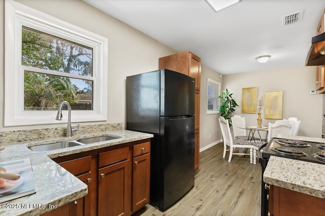 10625 Dodd Rd, Jacksonville, FL 32218 - kitchen with a sink, visible vents, black appliances, and light stone counters