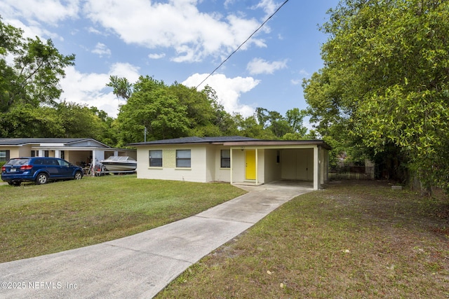bungalow with a carport, a front lawn, and concrete driveway