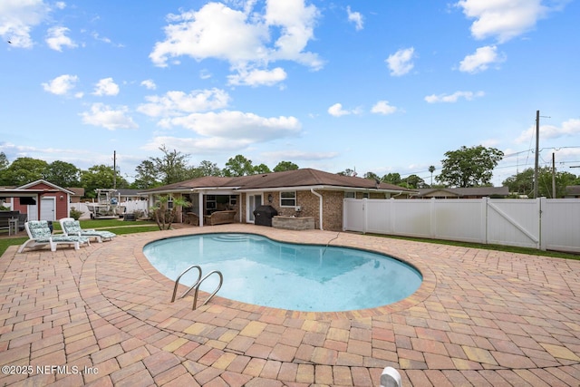 706 Montego Rd E, Jacksonville, FL 32216 - view of pool featuring an outbuilding, a patio area, fence, a gate, and a fenced in pool