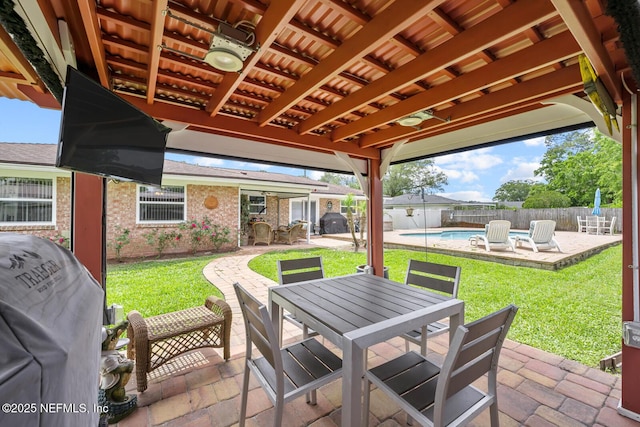 706 Montego Rd E, Jacksonville, FL 32216 - view of patio featuring grilling area, fence, a fenced in pool, and outdoor dining area