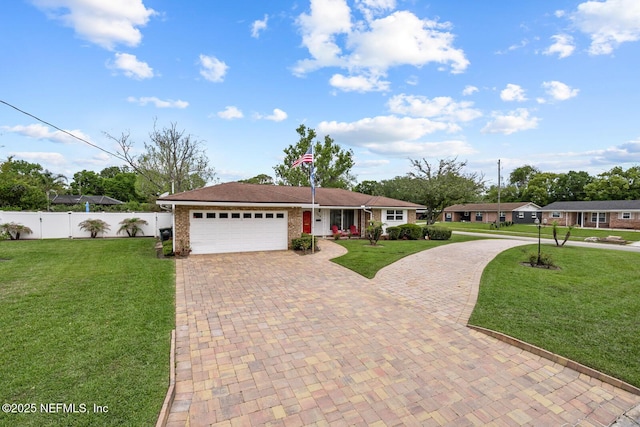 706 Montego Rd E, Jacksonville, FL 32216 - single story home featuring a front lawn, fence, a garage, and decorative driveway