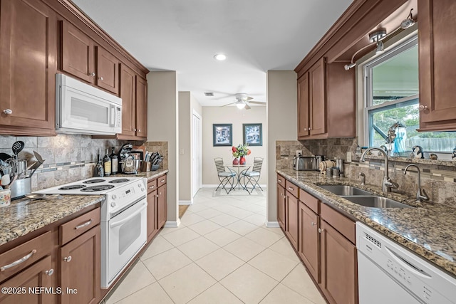 706 Montego Rd E, Jacksonville, FL 32216 - kitchen with a sink, ceiling fan, white appliances, and decorative backsplash