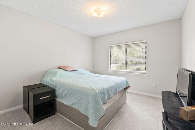 bedroom with baseboards, a textured ceiling, and carpet floors