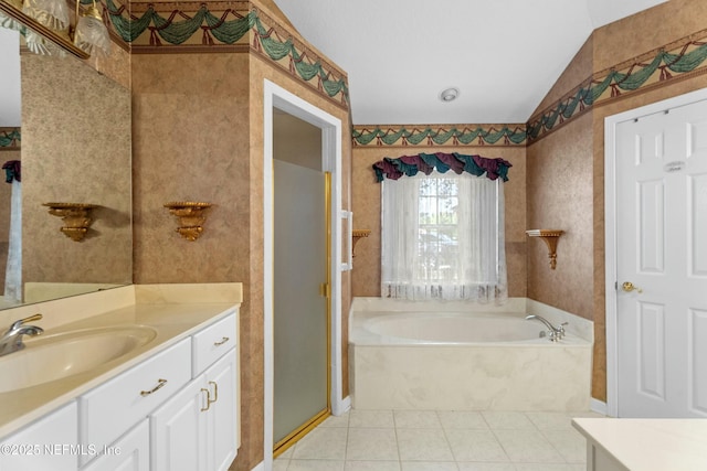 4261 Via Valencia Cir, Jacksonville, FL 32217 - bathroom featuring a bath, vanity, tile patterned floors, a stall shower, and lofted ceiling