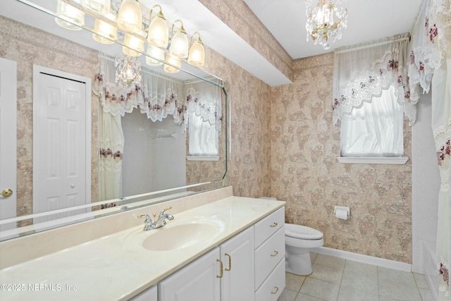 4261 Via Valencia Cir, Jacksonville, FL 32217 - bathroom with vanity, a chandelier, toilet, wallpapered walls, and baseboards