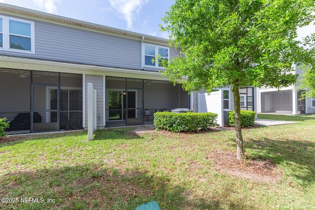 2627 Sandy Dune Dr, Jacksonville, FL 32233 - rear view of property with a sunroom and a lawn
