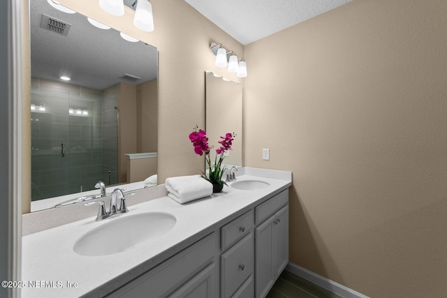 2627 Sandy Dune Dr, Jacksonville, FL 32233 - bathroom featuring double vanity, visible vents, a sink, and a stall shower