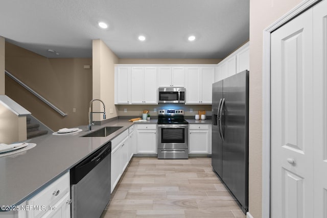 2627 Sandy Dune Dr, Jacksonville, FL 32233 - kitchen featuring appliances with stainless steel finishes, a sink, white cabinets, and recessed lighting