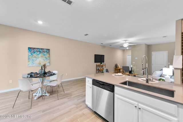 2627 Sandy Dune Dr, Jacksonville, FL 32233 - kitchen featuring light wood-style flooring, a ceiling fan, white cabinets, dishwasher, and a sink