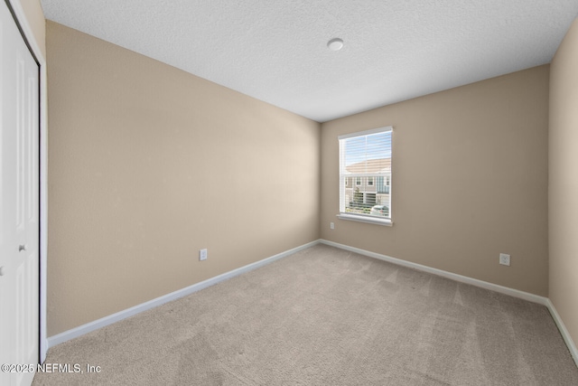2627 Sandy Dune Dr, Jacksonville, FL 32233 - carpeted spare room with a textured ceiling and baseboards