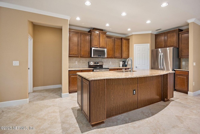 205 Clay Gully Trl, Ponte Vedra, FL 32081 - kitchen featuring stainless steel appliances, a sink, ornamental molding, backsplash, and a kitchen island with sink