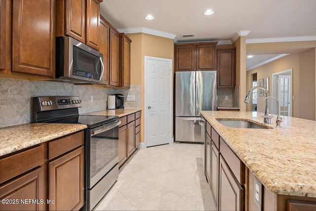 205 Clay Gully Trl, Ponte Vedra, FL 32081 - kitchen featuring stainless steel appliances, a sink, crown molding, light stone counters, and tasteful backsplash