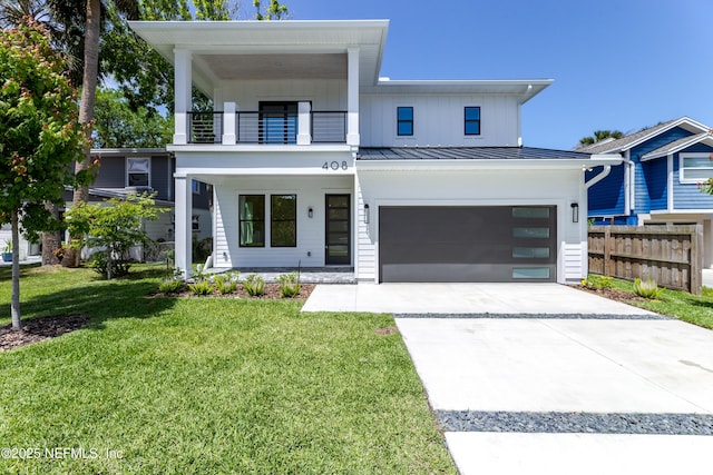 view of front of house featuring a front yard, a garage, fence, a balcony, and driveway