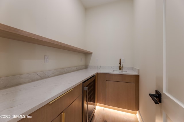 bar with indoor wet bar, a sink, and wine cooler