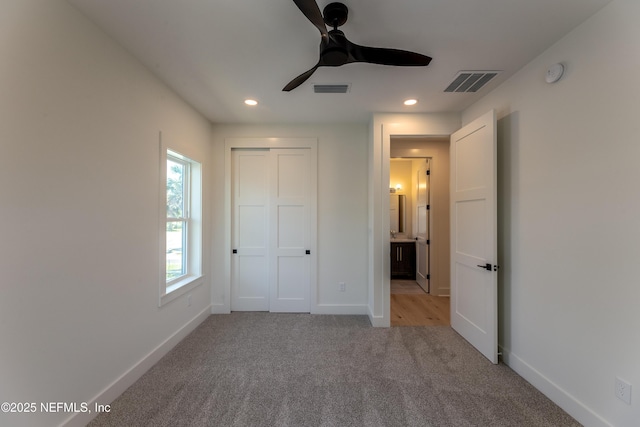 unfurnished bedroom featuring visible vents, baseboards, recessed lighting, and light carpet