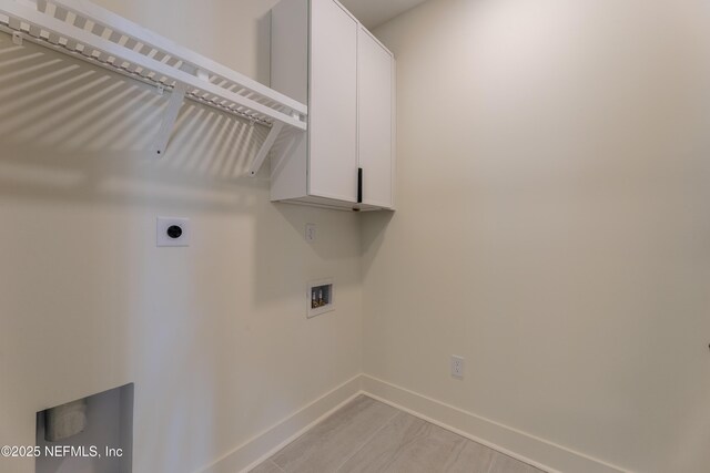 laundry area featuring cabinet space, baseboards, and hookup for a washing machine