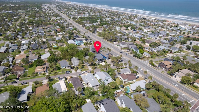 birds eye view of property featuring a water view, a residential view, and a view of the beach
