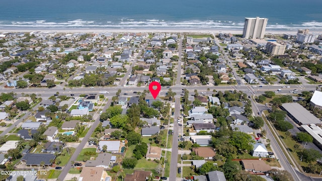 bird's eye view featuring a water view and a beach view