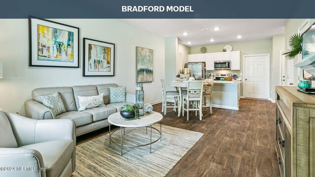 living room featuring recessed lighting, dark wood-type flooring, and baseboards