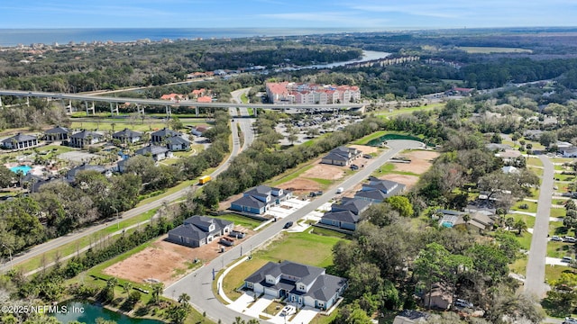 drone / aerial view with a water view and a residential view