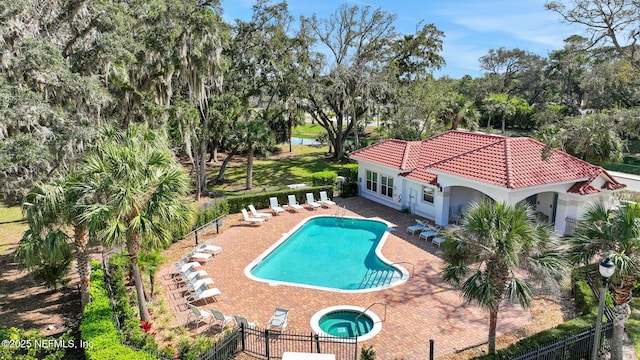 pool with a patio, fence private yard, and a hot tub