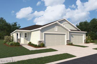 craftsman inspired home with a garage, a front yard, and concrete driveway
