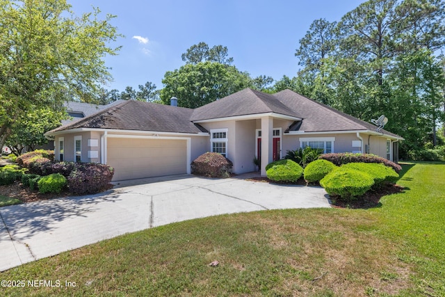 ranch-style home with a shingled roof, stucco siding, an attached garage, concrete driveway, and a front yard