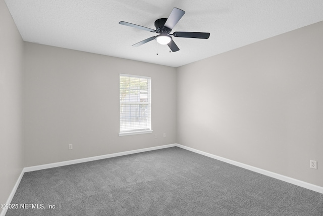 spare room featuring baseboards and carpet