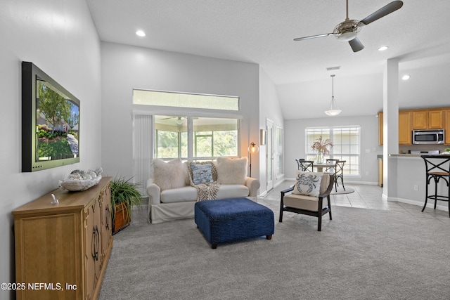 living area featuring recessed lighting, a ceiling fan, light carpet, light tile patterned flooring, and baseboards