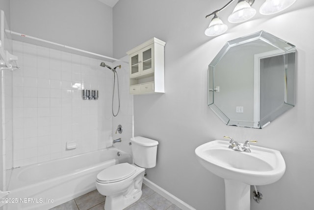 full bathroom featuring a sink,  shower combination, baseboards, toilet, and tile patterned flooring