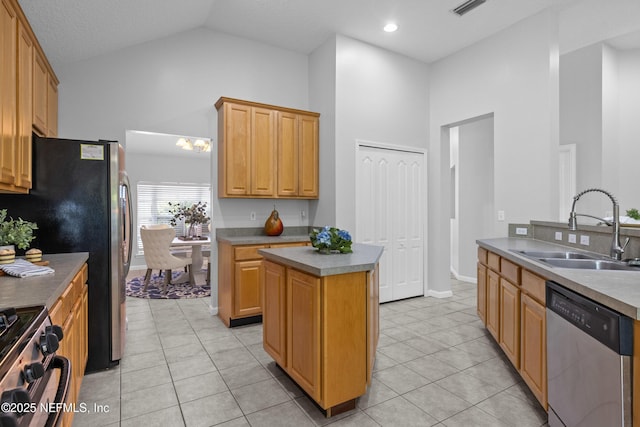 kitchen featuring dishwasher, gas range oven, light tile patterned flooring, and a sink