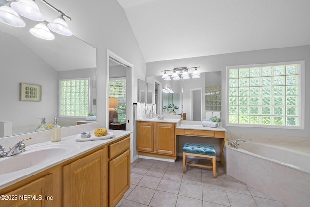 full bath featuring vanity, lofted ceiling, tile patterned flooring, and a garden tub
