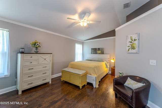 bedroom with dark wood finished floors, vaulted ceiling, baseboards, visible vents, and crown molding