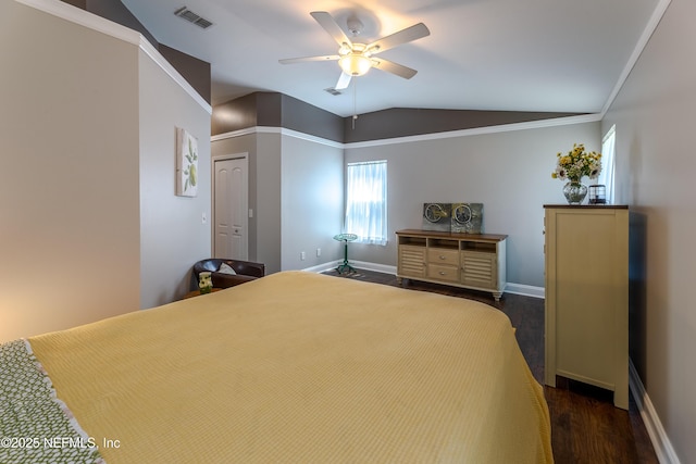 bedroom featuring dark wood finished floors, lofted ceiling, visible vents, and baseboards
